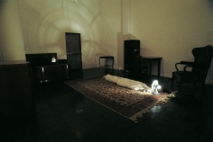 Hale Tenger, Shroud, 1996, Found furniture, carpet, fan, spotlight, toddler shoes and photographs, and shroud